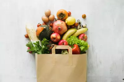 groceries spilling out of a brown paper bag