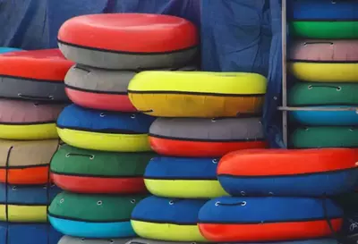 inner tubes stacked up against a wall