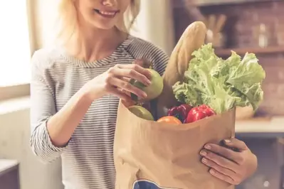 woman holding bag of groceries in cabin