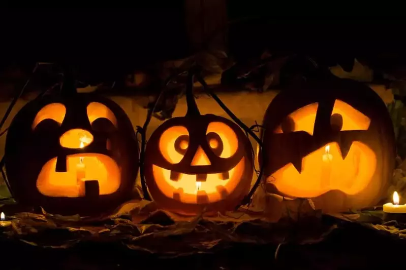 Carved pumpkins lit up at night