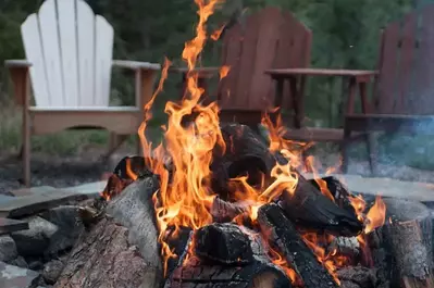 An outdoor firepit with chairs around it.