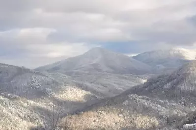 Stunning winter photo of the snow covered mountains in Gatlinburg.