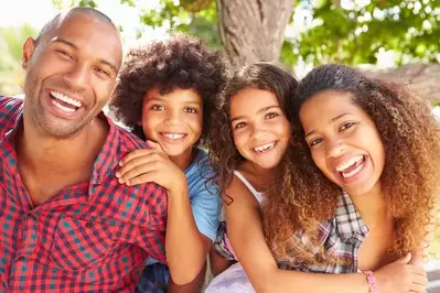 Happy family of four on vacation.