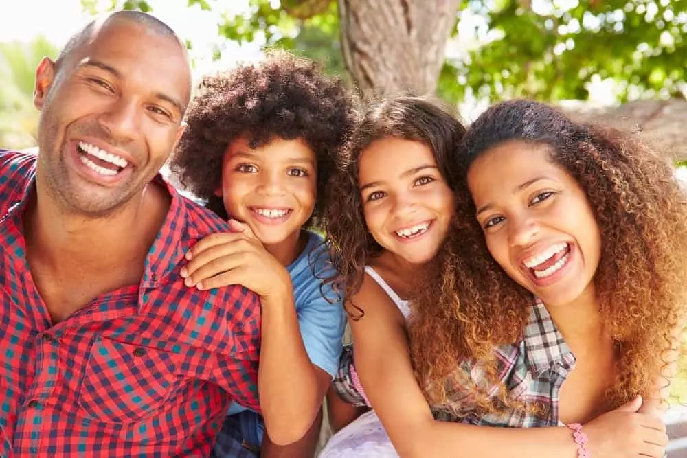 Happy family of four on vacation.