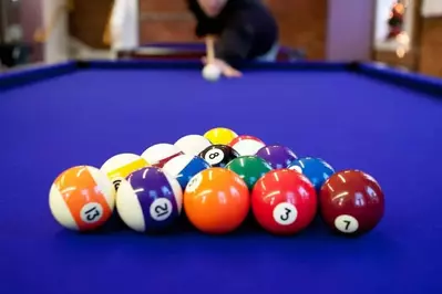 Man playing pool in a Pigeon Forge cabin with a game room