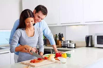 Happy couple cooking together in their one bedroom Gatlinburg cabin