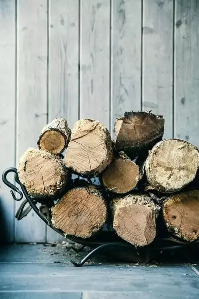 Firewood stacked outside of a cabin