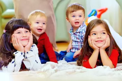 Four kids watching a movie