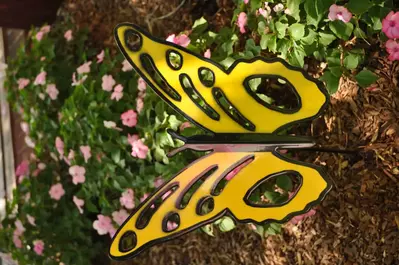 Yellow butterfly decor in a flower bed at Dollywood