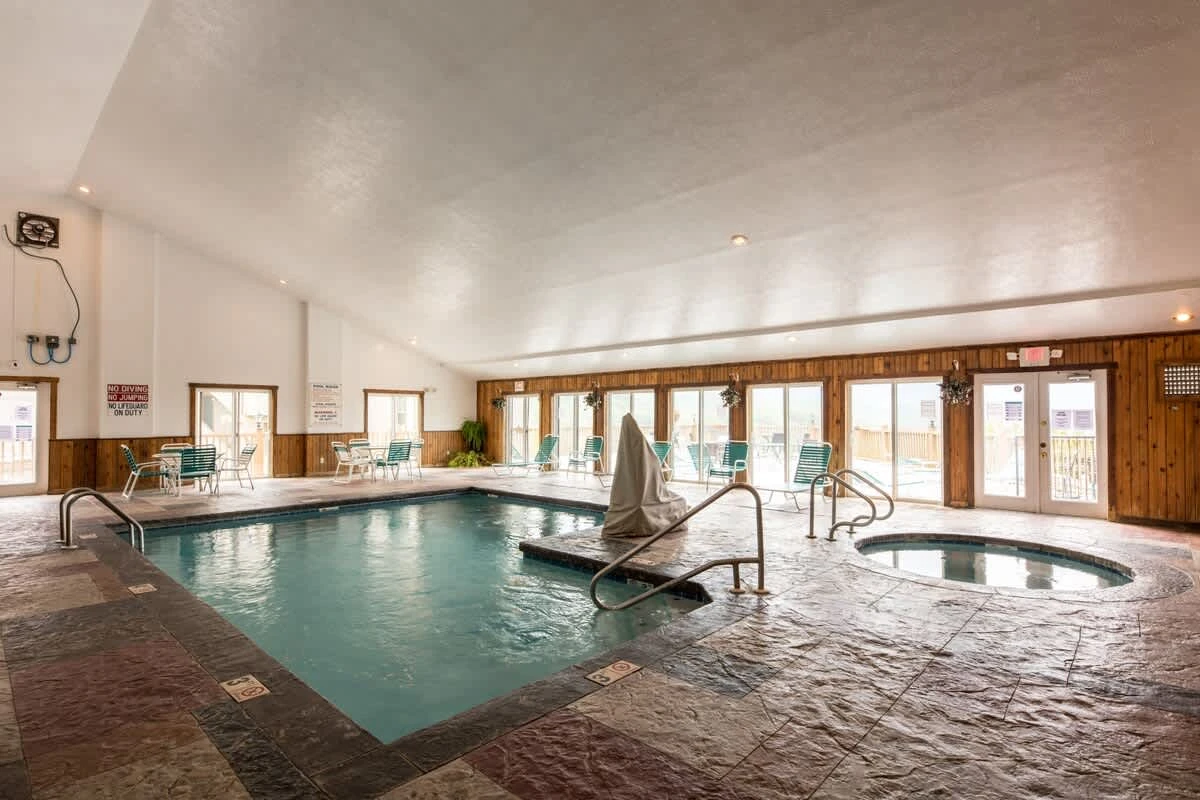 The indoor pool area includes a hot tub, steam room, and sauna.