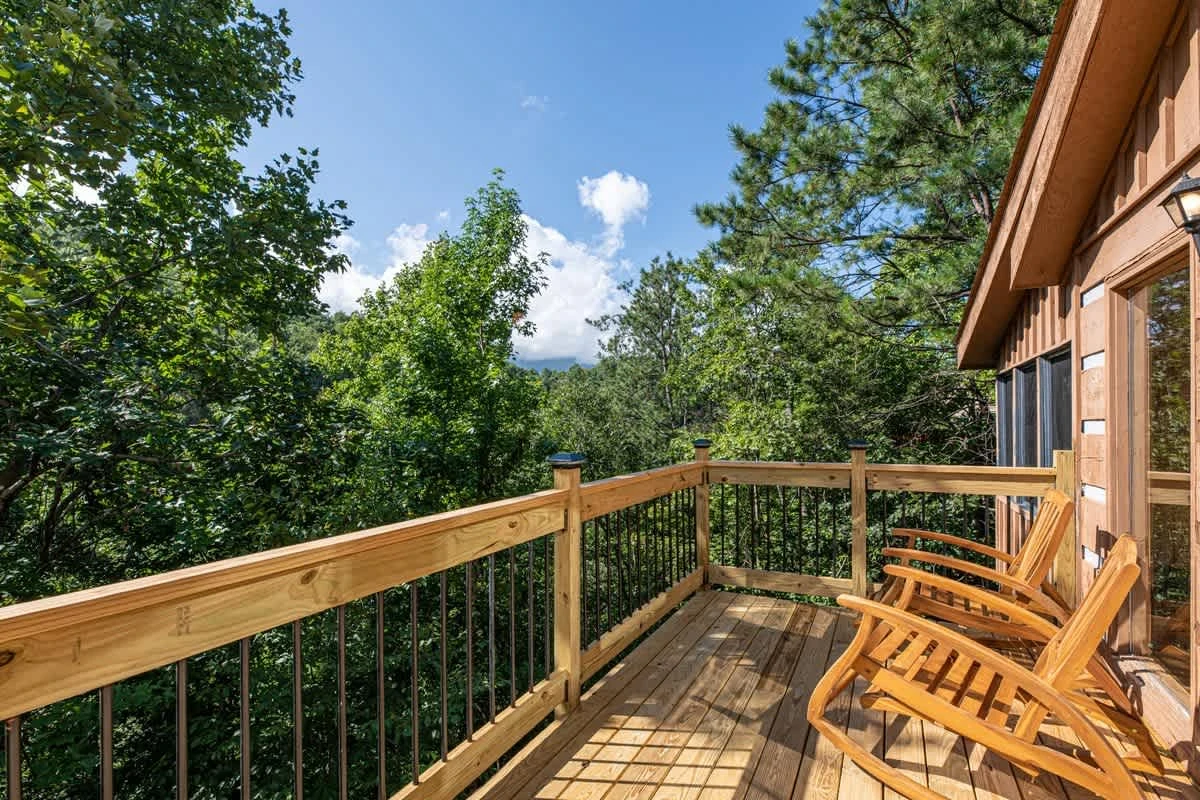 Deck features patio furniture on the right of living area entrance.