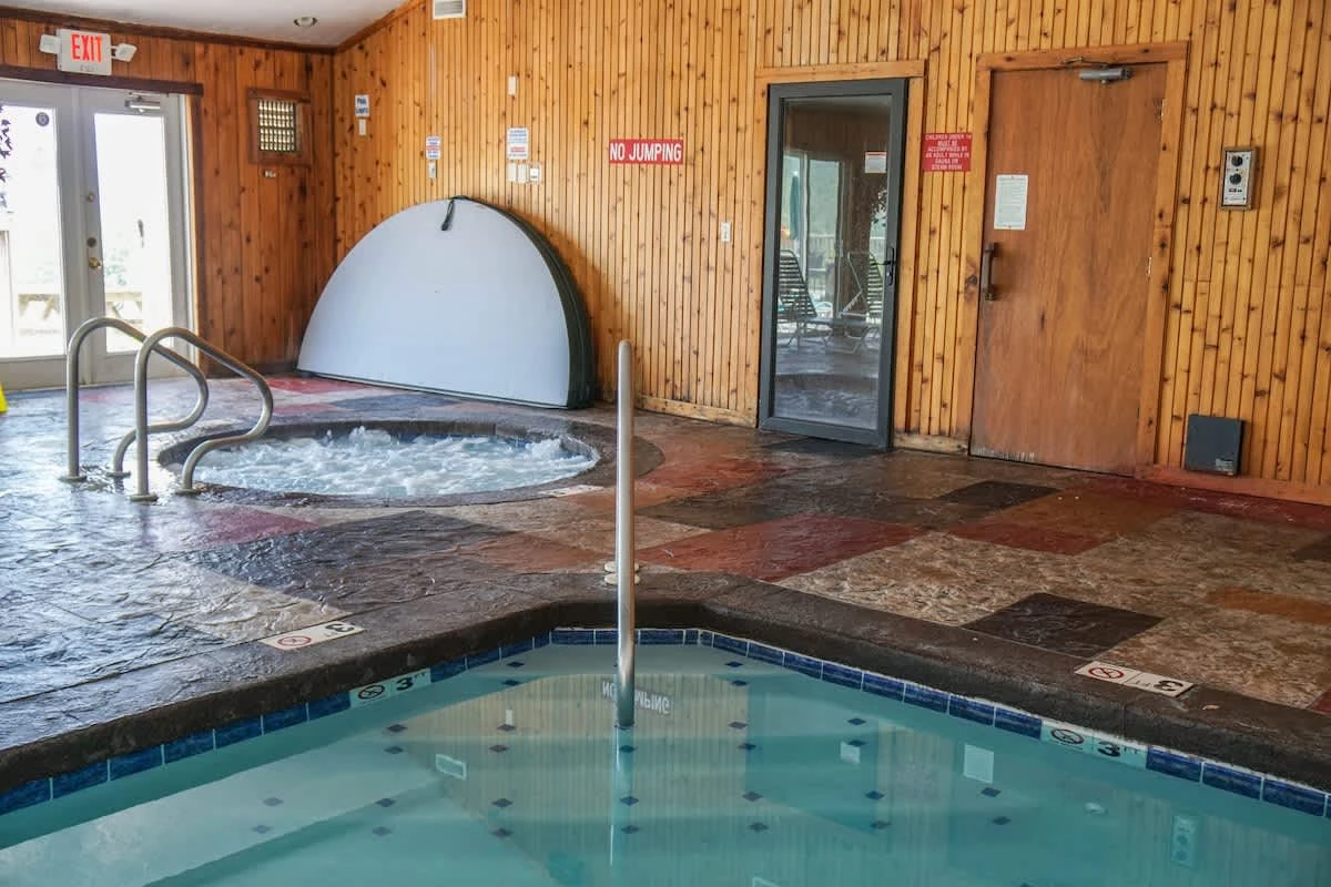 The indoor pool area includes a hot tub, steam room, and sauna.